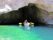 Kayakers paddle at Emerald Cave on the Arizona side of the Colorado River.