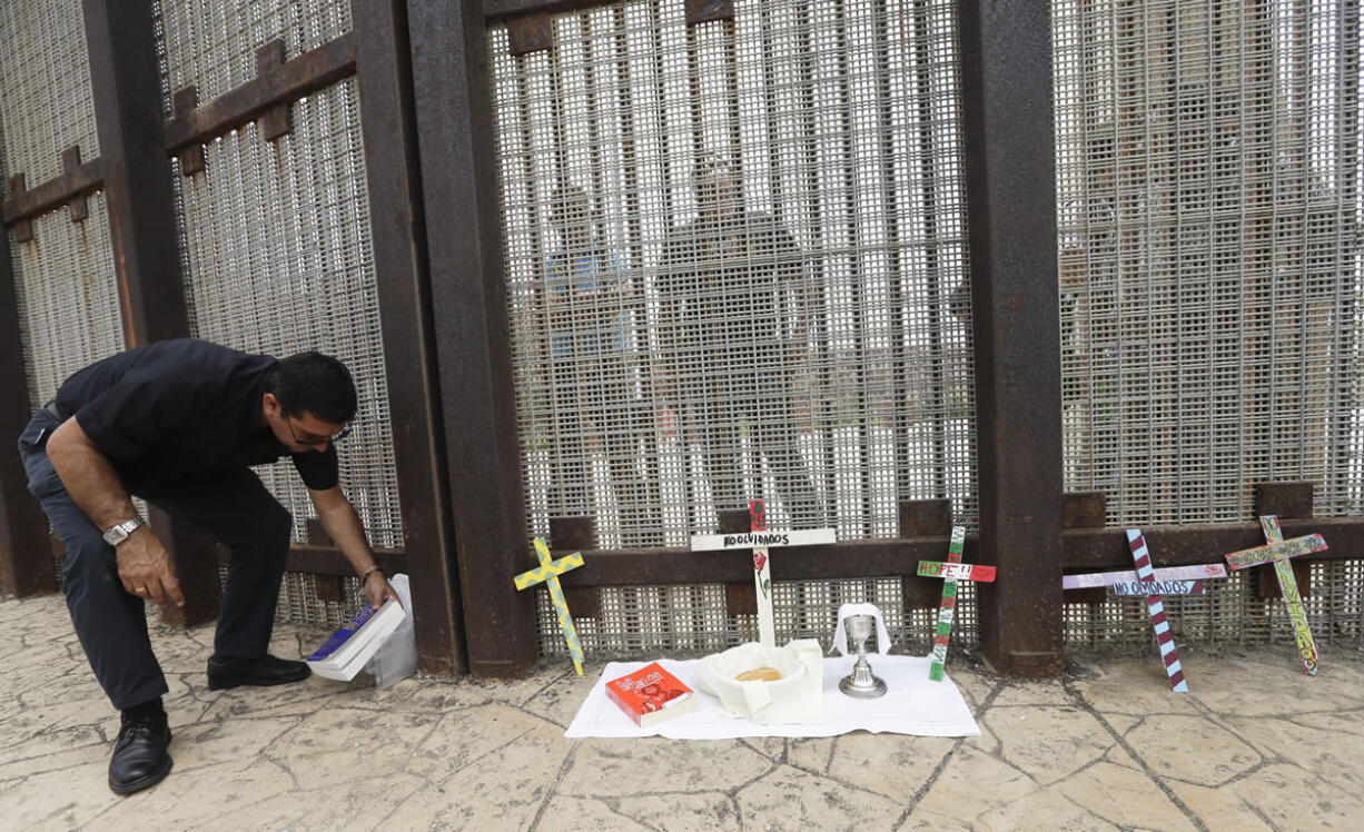 Father Agustin Mendez prepares to celebrate a Sunday Mass on July 14 along the fence between San Diego and Tijuana, Mexico. San Diego is a border city but it often does not feel like one despite the fact its center is less than a 20-minute drive to Mexico.