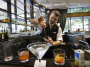 Bartender Derek Simoes mixes drinks July 3 in the newly redesigned bar at a Sheraton hotel in Seattle.