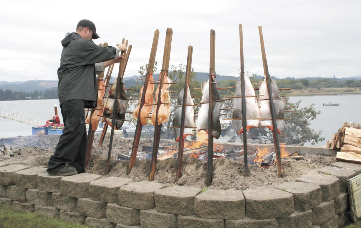 Chef Chris Foltz cooks 20- to 30-pound salmon on stakes for the Coquille Tribe's annual Salmon Celebration on Sept.