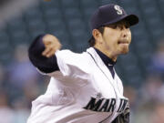 Mariners starting pitcher Hisashi Iwakuma throws against the Minnesota Twins in the fifth inning.