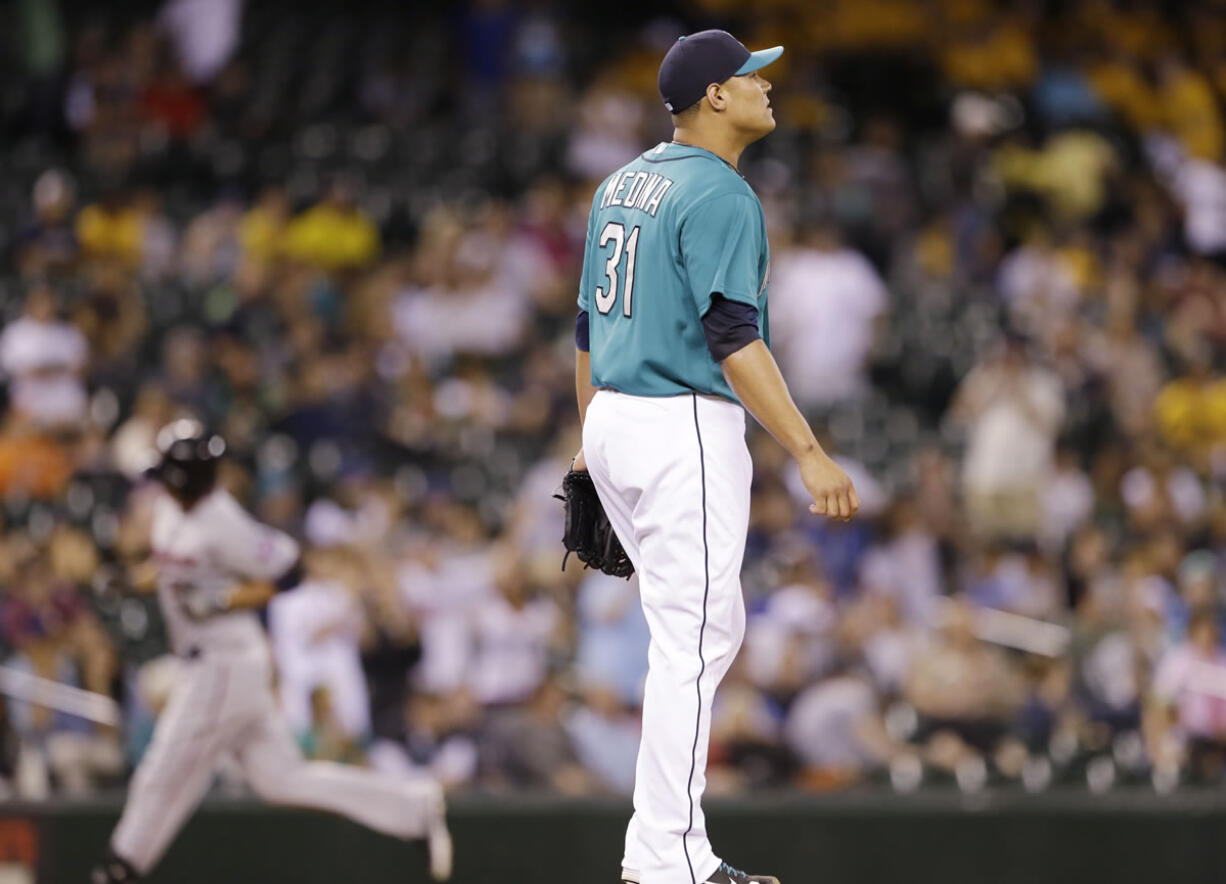 Seattle Mariners relief pitcher Yoervis Medina (31) looks away as Minnesota Twins' Chris Colabello rounds the bases behind on his two-run home run in the 13th inning Friday.