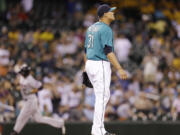 Seattle Mariners relief pitcher Yoervis Medina (31) looks away as Minnesota Twins' Chris Colabello rounds the bases behind on his two-run home run in the 13th inning Friday.