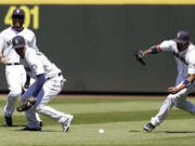 Seattle Mariners right fielder Endy Chavez, right, races to the ball from Minnesota Twins' Chris Colabello that fell between center fielder Dustin Ackley, left, and second baseman Nick Franklin in the fourth inning Saturday.