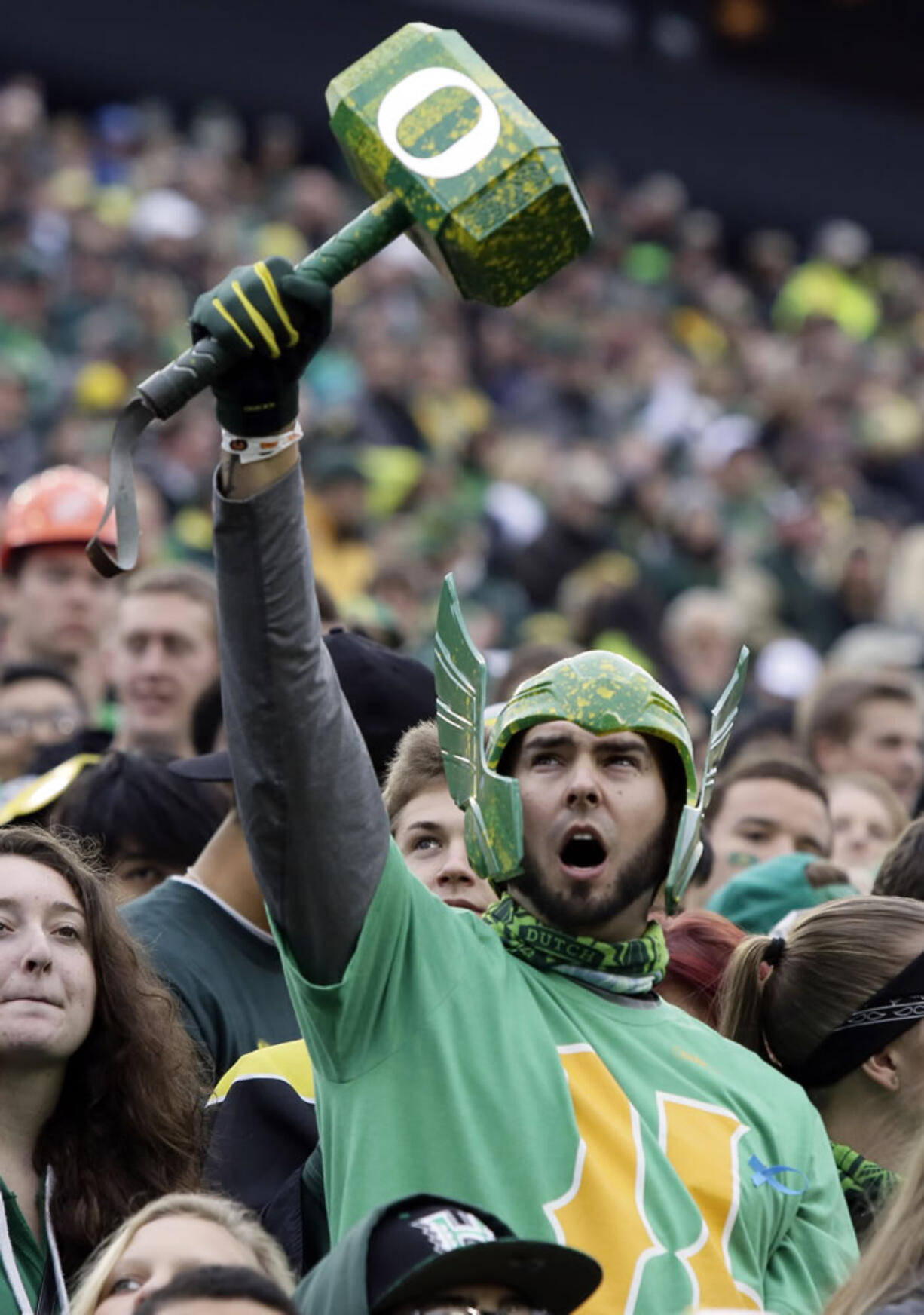 An Oregon fan cheers during the first half of an NCAA college football game against UCLA in Eugene, Ore., Saturday, Oct. 26, 2013.