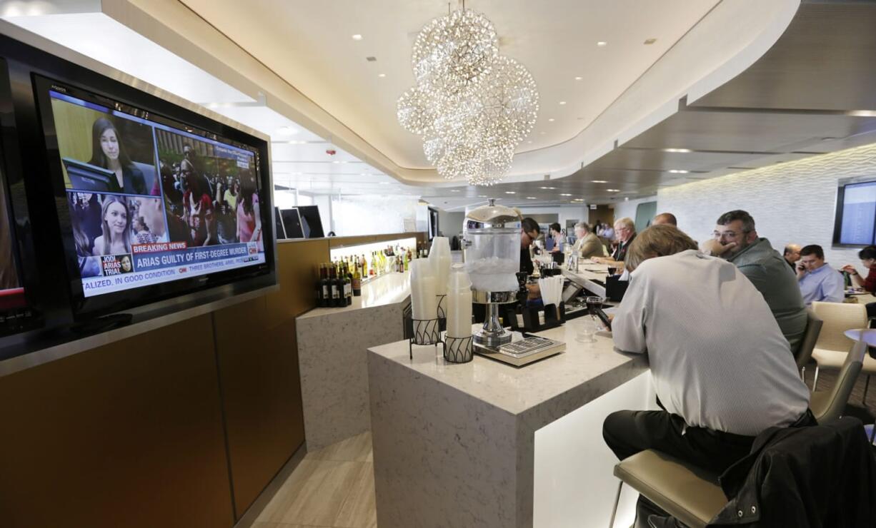 United Airlines passengers enjoy the United Club as they wait for their flights at O'Hare International Airport in Chicago.