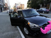 Katie Baranyuk gets out of a car driven by Dara Jenkins after a Lyft ride to downtown Seattle in March 2014. Seattle may soon let drivers collectively bargain with ride-hailing companies over pay and working conditions.