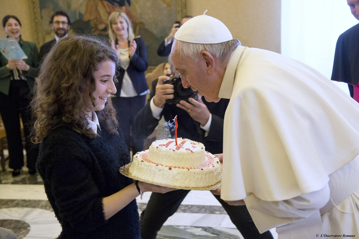 Pope Francis blows a candle on a birthday cake Thursday at the Vatican. The pontiff turned 79.