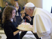 Pope Francis blows a candle on a birthday cake Thursday at the Vatican. The pontiff turned 79.