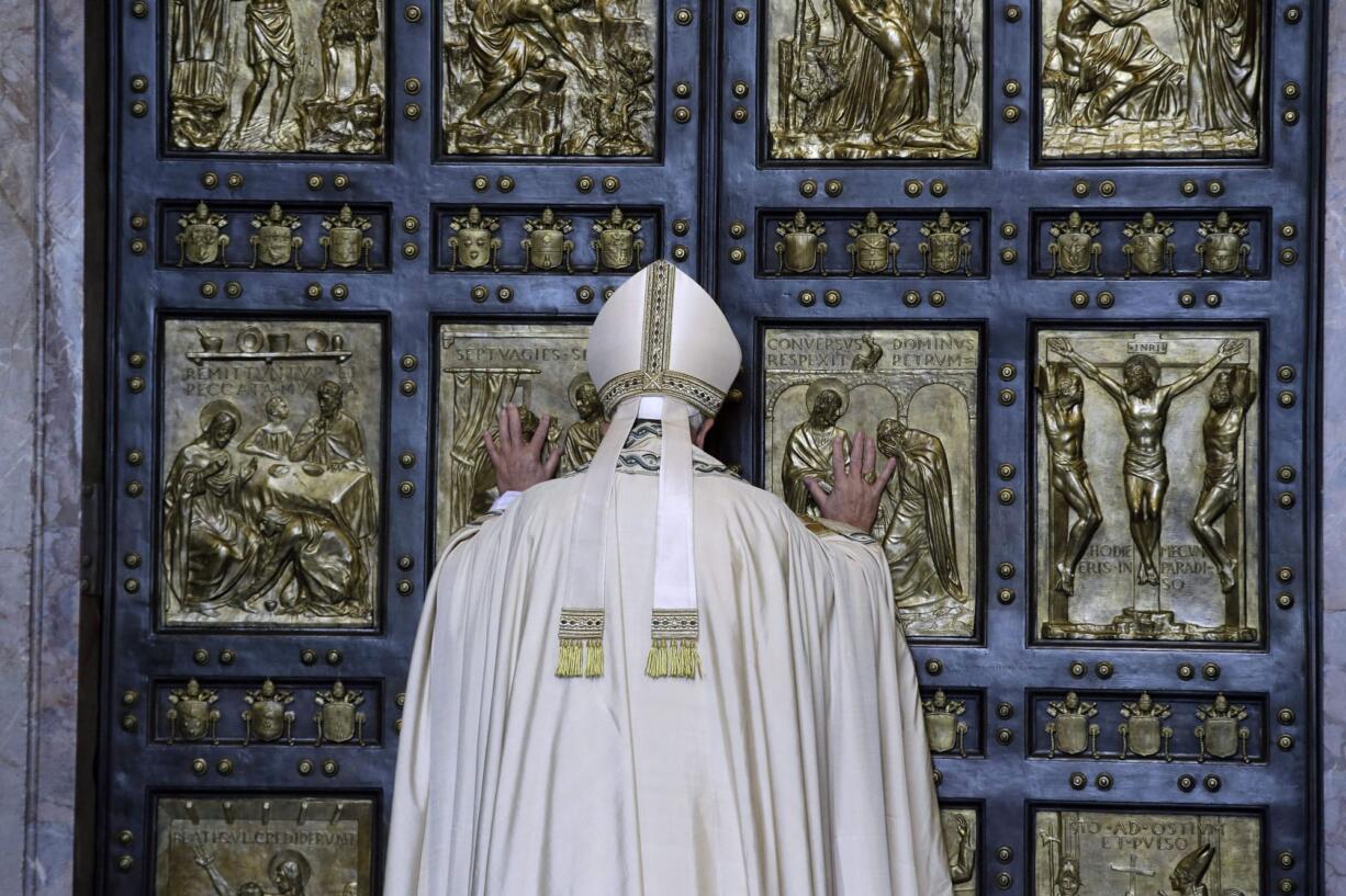 Pope Francis pushes open the Holy Door of St. Peter&#039;s Basilica on Tuesday at the Vatican, formally launching the Holy Year of Mercy.