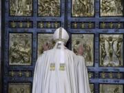 Pope Francis pushes open the Holy Door of St. Peter&#039;s Basilica on Tuesday at the Vatican, formally launching the Holy Year of Mercy.