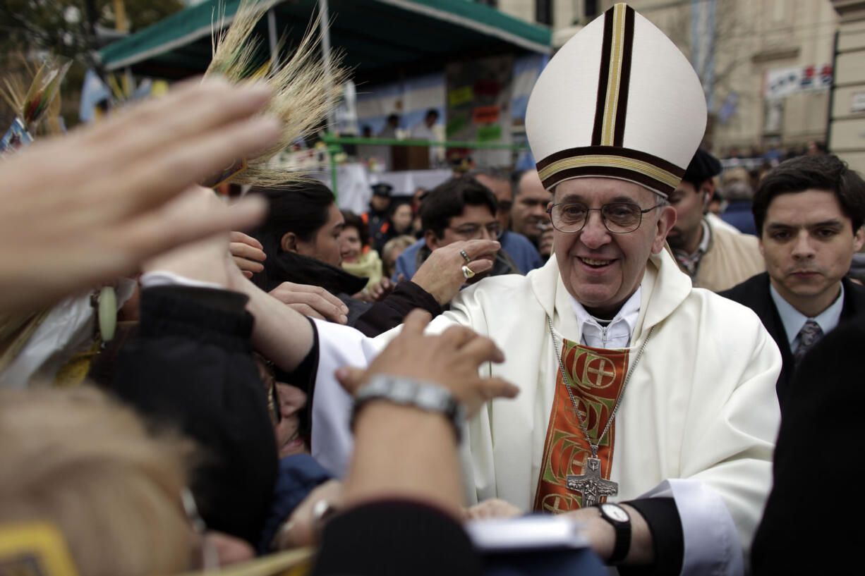 Argentina's Cardinal Jorge Bergoglio, right, gives a mass outside San Cayetano church in Buenos Aires.