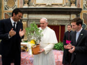 Pope Francis is applauded by Italy goalie Gianluigi Buffon, left, and Argentine soccer star Lionel Messi during a private audience at the Vatican on Tuesday.