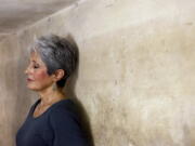 Joan Baez stands with her back to the wall of an historic bomb shelter under the Metropole Hotel in Hanoi, Vietnam.