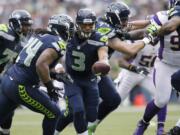 Seattle Seahawks quarterback Russell Wilson hands off to Marshawn Lynch (24) during the first half of an NFL football game against the Minnesota Vikings, Sunday, Nov. 4, 2012, in Seattle.