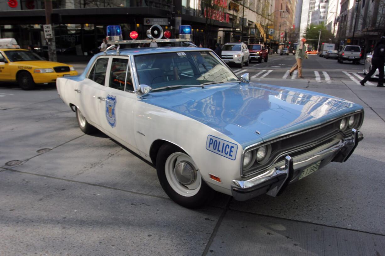 A 1970 Plymouth Satellite police cruiser is parked Tuesday in downtown Seattle as Officer Jim Ritter responds to a call.