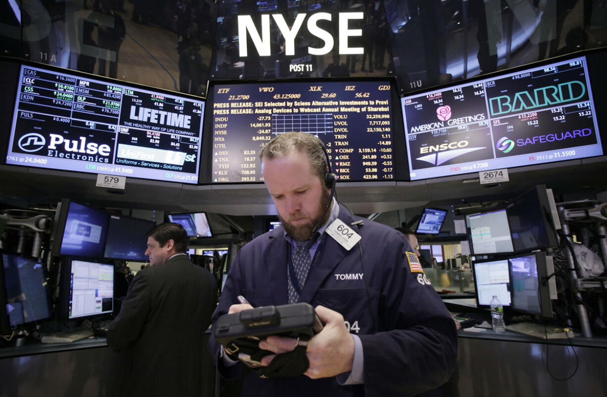 Stock trader Thomas Lyden works at the New York Stock Exchange on Monday in New York.