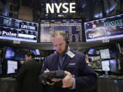 Stock trader Thomas Lyden works at the New York Stock Exchange on Monday in New York.