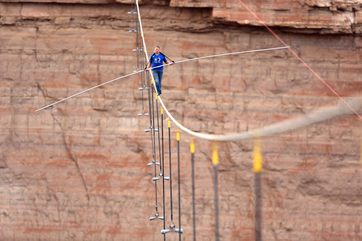 Aerialist Nik Wallenda walks a 2-inch-thick steel cable taking him a quarter mile over the Little Colorado River Gorge, Ariz., on Sunday.