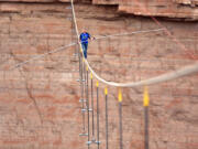 Aerialist Nik Wallenda walks a 2-inch-thick steel cable taking him a quarter mile over the Little Colorado River Gorge, Ariz., on Sunday.