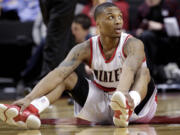 Don Ryan/The Associated Press
Portland Trail Blazers guard Damian Lillard sits on the floor after losing the ball during the second half of an basketball game  against the Golden.