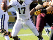 Washington quarterback Keith Price (17) looks to pass against Arizona State during the first half of an NCAA college football game, Saturday, Oct. 19, 2013, in Tempe, Ariz.