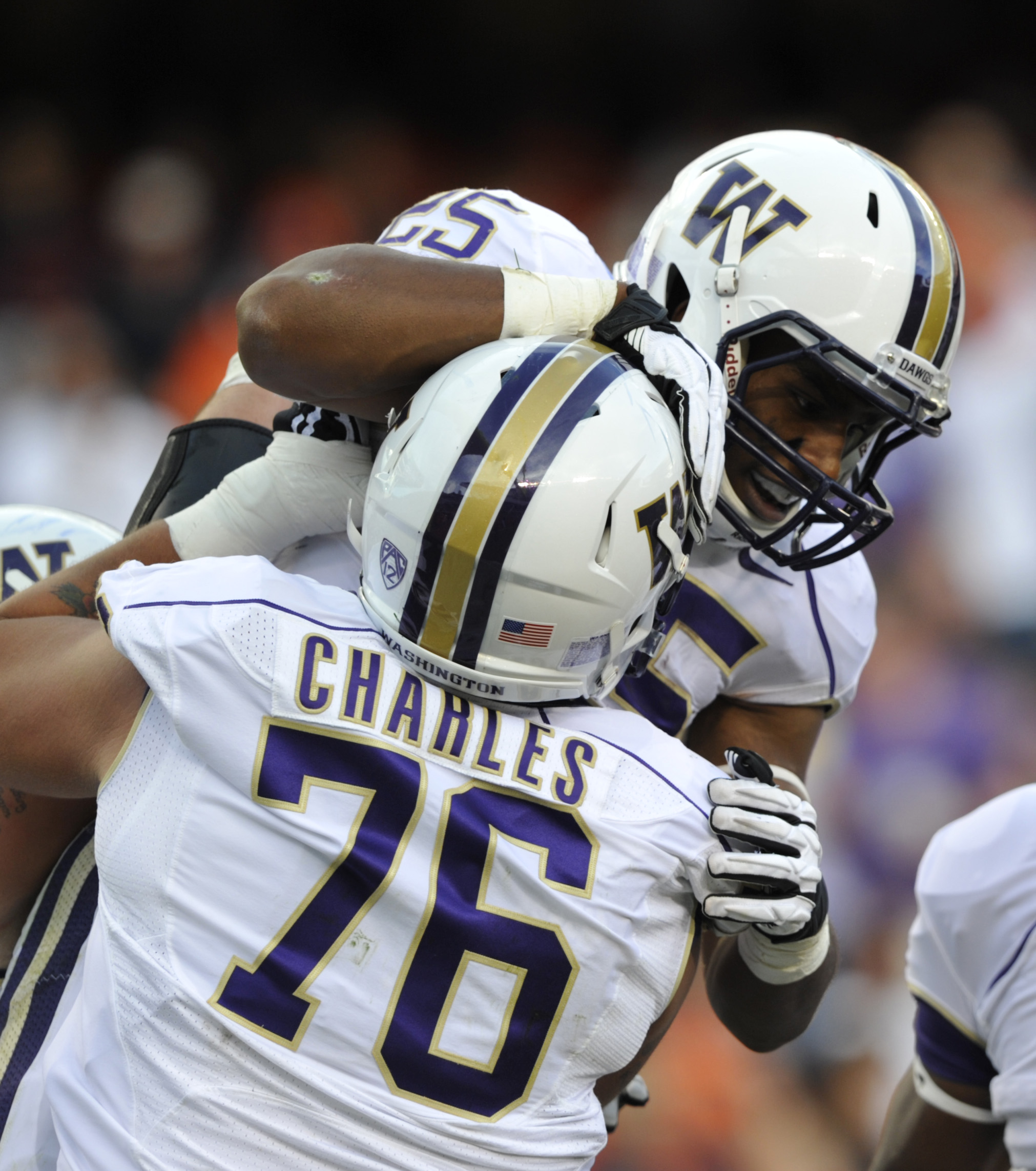 Washington's Bishop Sankey (25) celebrates his touchdown against Illinois with Dexter Charles during the first half Saturday at Soldier Field in Chicago.