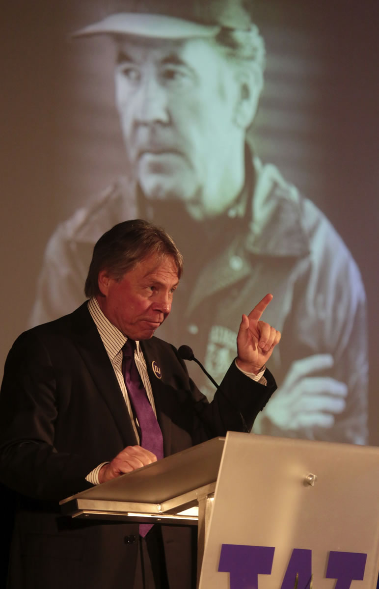 Bob Rondeau talks about the infamous look that former University of Washington coach Don James carried, captured in the photo projected behind him during James' memorial service at Alaska Airlines Arena (HecEd Pavilion) in Seattle, Sunday Oct. 27, 2013.