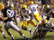 LSU running back Alfred Blue (4) rushes for a portion of his 101 yards Saturday against Washington.