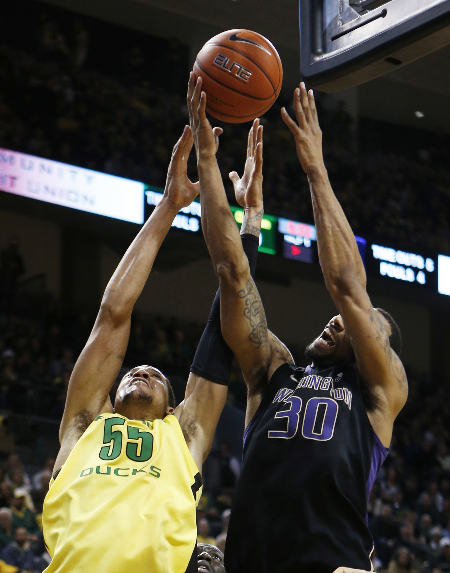 Oregon's Tony Woods, left, battles Washington's Desmond Simmons for a rebound during the first half Saturday.