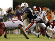 Washington State safety Taylor Taliulu (30) knocks the ball loose from Auburn running back Tre Mason during the second half  Saturday.