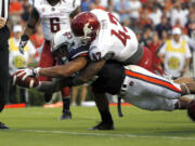 Auburn running back Tre Mason (21) dives for the end zone for a touchdown with Washington State linebacker Cyrus Coen (42) during the first quarter Saturday.