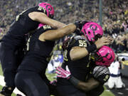 Oregon running back Byron Marshall, right, celebrates his touchdown with teammates, from left, Tyler Johnstone, Hamani Stevens and Hroniss Grasu during the first half of an NCAA college football game against Washington State in Eugene, Ore., Saturday, Oct. 19, 2013.