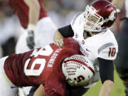 Washington State quarterback Jeff Tuel (10) is brought down by Stanford defensive end Ben Gardner during the second half Saturday.