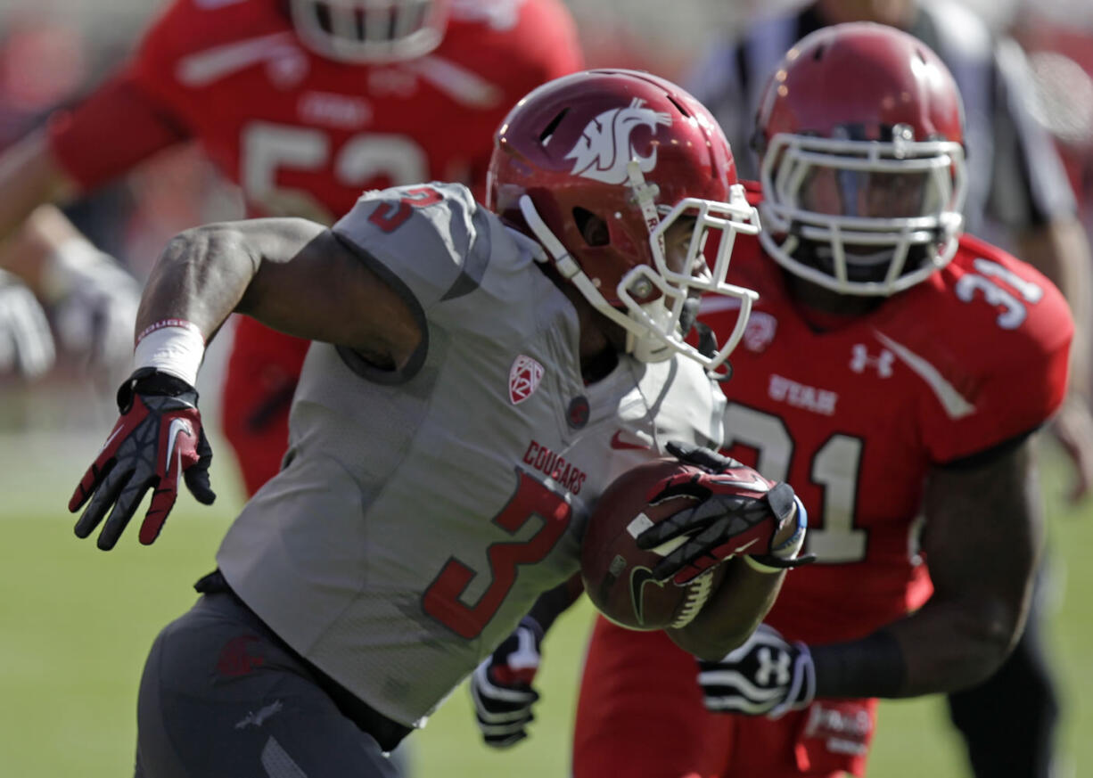 Washington State running back Carl Winston (3) carries the ball as Utah linebacker Victor Spikes (31) pursues in the first quarter during an NCAA college football game on Saturday, Nov. 3, 2012, in Salt Lake City. Utah defeated Washington State 49-6.