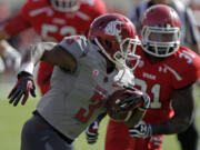 Washington State running back Carl Winston (3) carries the ball as Utah linebacker Victor Spikes (31) pursues in the first quarter during an NCAA college football game on Saturday, Nov. 3, 2012, in Salt Lake City. Utah defeated Washington State 49-6.