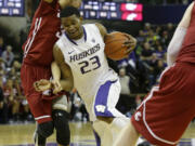 Washington's C.J. Wilcox (23) drives around Washington State's Dexter Kernich-Drew, left, in the second half Sunday.