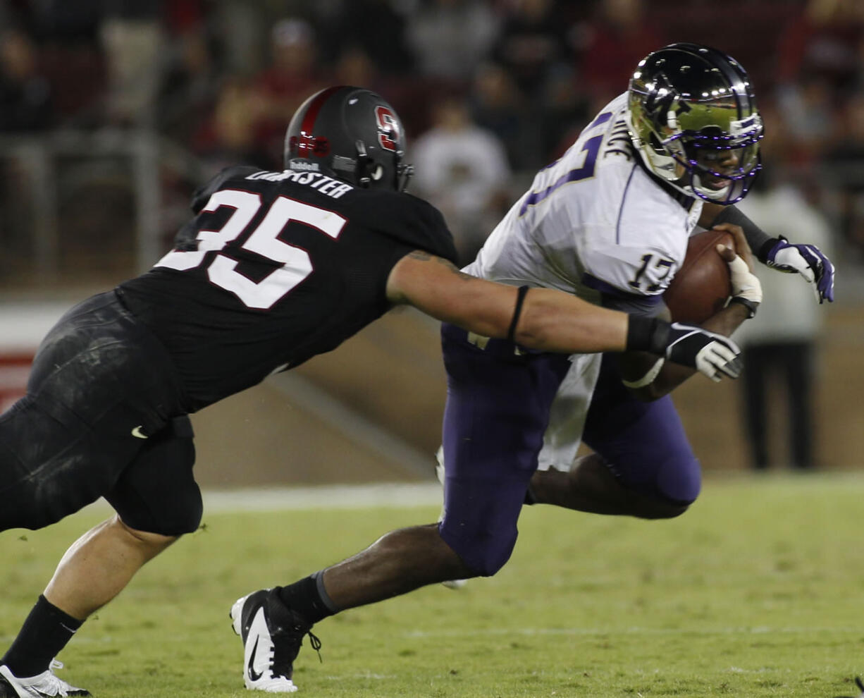 Washington quarterback Keith Price, right, is tackled by  Stanford's Jarek Lancaster during the second half of an NCAA college football game in Stanford, Calif., Saturday, Oct. 5, 2013.