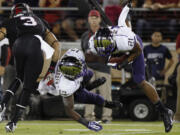 Washington's Marcus Peters, right, makes an interception against Stanford during the first half Saturday.