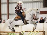 Jessica Bishop, of Scio, Ore., riding Chief Seattle, competes in the Craig Cameron Extreme Cowboy Race at the Washington State Horse Expo, held at the Clark County Event Centeron Feb.