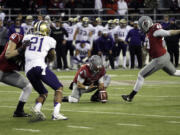 Washington State's Andrew Furney, right, kicks the game-winning field goal in overtime against Washington on Friday.