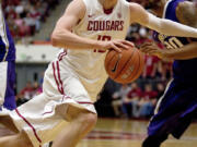 Washington State forward Brock Motum (12) drives against Washington forward Desmond Simmons (30) during the first half Saturday.