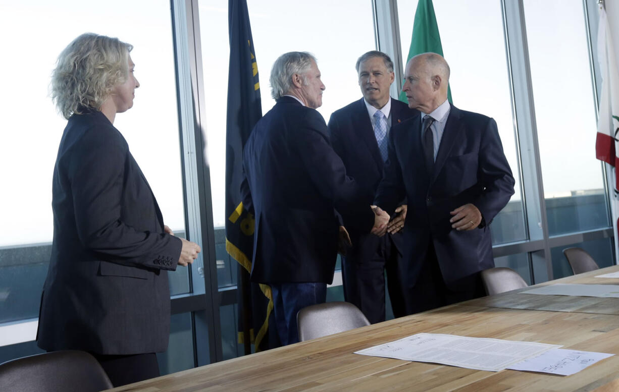 Mary Polak, from left, environment minister of British Columbia, representing British Columbia premier Christy Clark, looks on as Oregon Gov. John Kitzhaber, Washington Gov. Jay Inslee and California Gov.