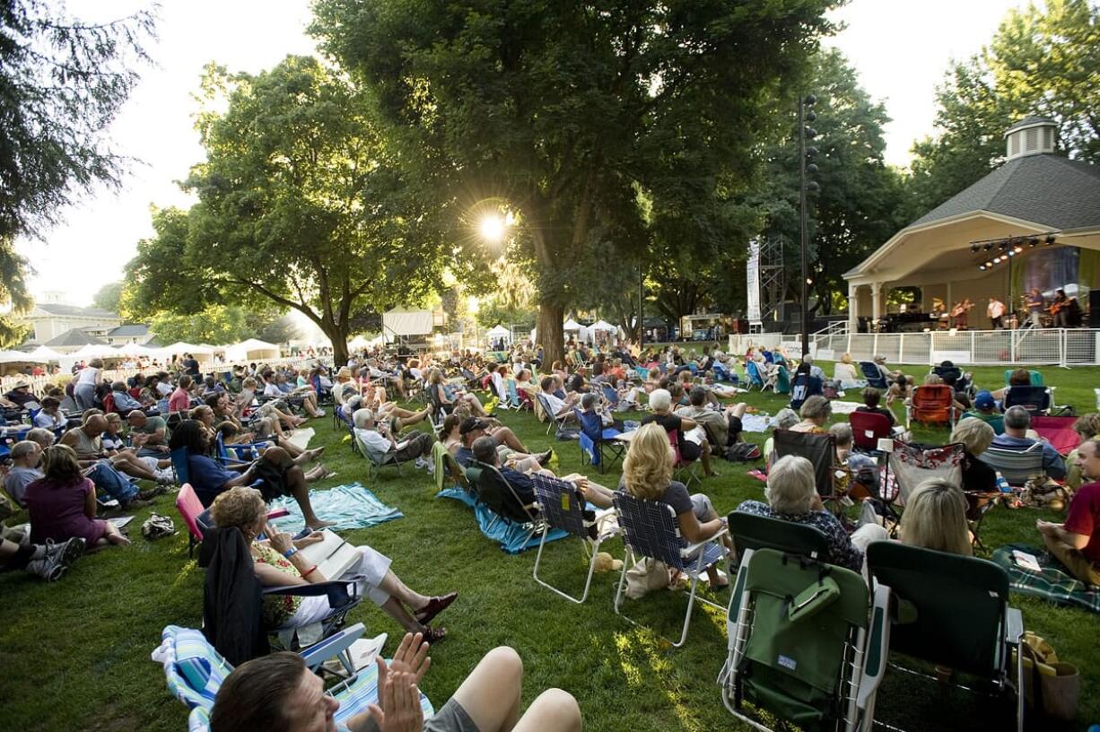 Music fans listen to the Tacoma band Junkyard Jane on the opening night of the 2011 Vancouver Wine and Jazz Festival at Esther Short Park.