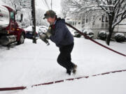 Delivery truck driver Donald Whitacre, of Gore, Va., returns to his truck after pumping 200-gallons of home heating oil into a customer's tank during heavy snowfall in Winchester, Va. Chillier weather and slightly higher fuel prices may make the winter of 2013-14, the most expensive one in three years for U.S.