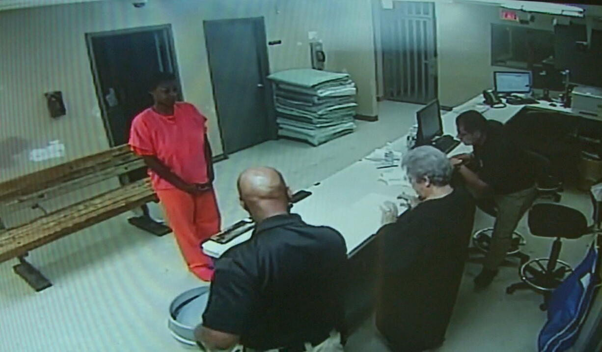 In this undated file frame from video provided by the Waller County Sheriff&#039;s Department, Sandra Bland stands before a desk at Waller County Jail in Hempstead, Texas. A grand jury decided that neither sheriff&#039;s officials nor jailers committed a crime in the treatment of Bland, a black woman who died in a Texas county jail last summer, but has not yet determined whether the state trooper who arrested her should face charges, a prosecutor said.