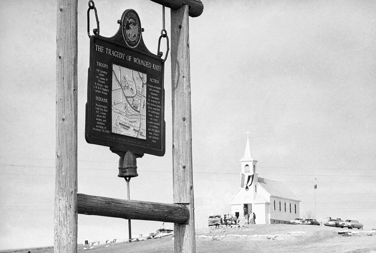 The historical marker commemorating the Wounded Knee Massacre of 1890 sits on the road near the Sacred Heart Catholic Church in Wounded Knee, S.D.