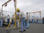 Students at The Northwest Renewable Energy Institute get a lesson in rigging as part of a wind turbine maintenance curriculum in August 2009. The Great Recession appears to have dramatically eroded the number of green industry jobs in Washington, the Employment Security Department said in a study released Monday.