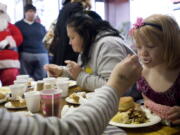 Stephanie Ollom, 4, gets a fork full of mashed potatoes from her mother Jennifer Ollom at Chronis' Restaurant and Lounge during the annual complementary Thanksgiving meal with all the trimmings on Thursday, November 24, 2011.