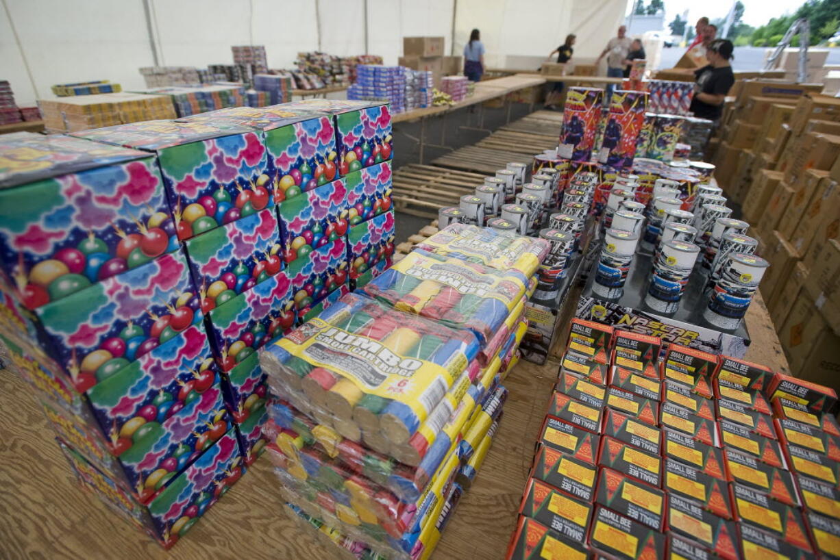 Friends and family of fallen soldier Sgt. John Kyle Daggett stock fireworks at the Wounded Warrior fireworks stand off Northeast Andersen Road on June 27, 2011. The stand raises money for veteran's needs.